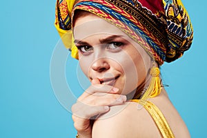 attractive woman bright makeup decoration ethnicity multicolored turban studio blue background