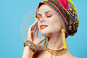 attractive woman bright makeup decoration ethnicity multicolored turban studio blue background