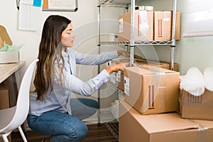 Female entrepreneur preparing to ship packages photo