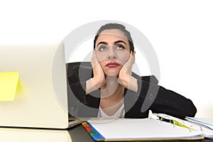 Attractive woman in business suit working tired and bored in office computer desk looking sad