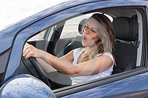 Attractive woman in car singing