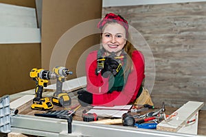 Attractive woman carpenter making sketch for furniture.