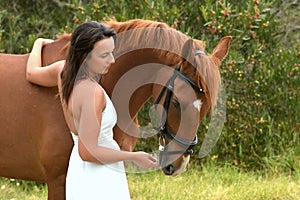 Attractive woman with chestnut horse