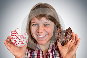 Attractive woman is choosing between two donuts