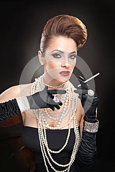 Attractive woman with cigare in studio
