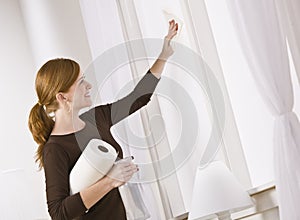 Attractive woman cleaning window