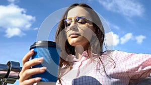 Attractive woman with coffee paper cup enjoying loneliness, solitude before work