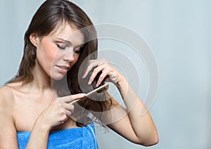 Attractive woman combing her hair