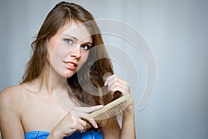 Attractive woman combing her hair