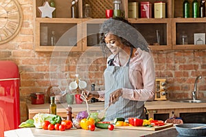 Attractive woman cooking healthy salad at kitchen