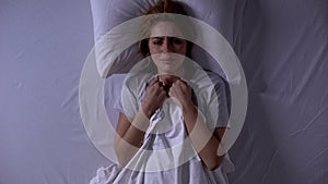 Attractive woman crying lying in bed at night, female weakness and fragility photo