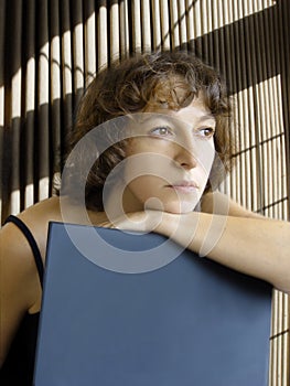 Attractive woman daydreaming with laptop