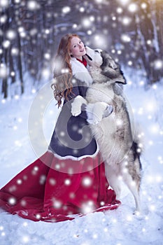 Attractive woman with the dogs. Huskies or Malamute