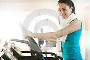 Attractive woman doing cardio exercise at gym