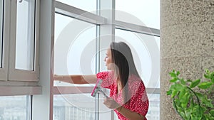 Attractive woman doing housework, washing big okgas at home. Housekeeping concept.