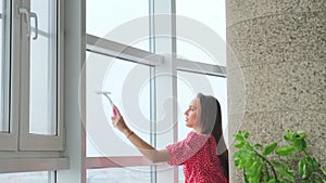 Attractive woman doing housework, washing big okgas at home. Housekeeping concept.