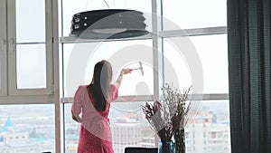 Attractive woman doing housework, washing big okgas at home. Housekeeping concept.