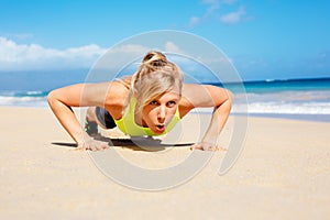 Attractive woman doing push ups outside.