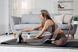Attractive woman doing relaxation exercise at home. Healthy lifestyle.