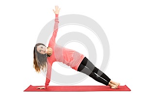 Attractive woman doing side plank pose