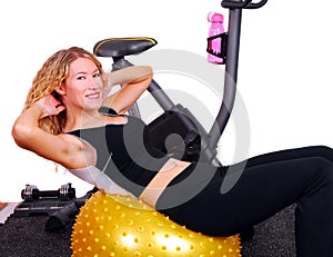 Attractive woman doing situps on an exercise ball photo