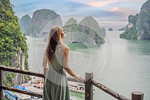 Attractive woman in a dress is traveling in Halong Bay. Vietnam. Travel to Asia, happiness emotion, summer holiday