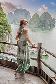 Attractive woman in a dress is traveling in Halong Bay. Vietnam. Travel to Asia, happiness emotion, summer holiday