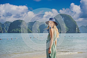 Attractive woman in a dress is traveling in Halong Bay. Vietnam. Travel to Asia, happiness emotion, summer holiday