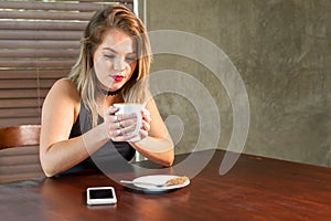 Attractive woman drinking a hot beverage