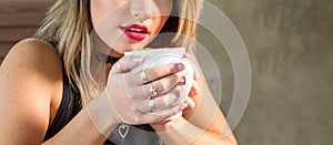 Attractive woman drinking a hot beverage