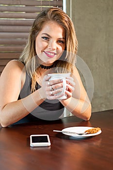 Attractive woman drinking a hot beverage