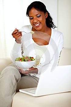 Attractive woman eating healthy salad