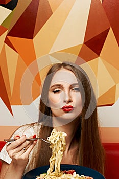 Attractive woman eating seafood pasta