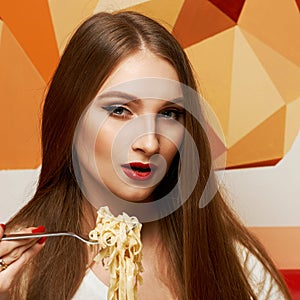 Attractive woman eating seafood pasta