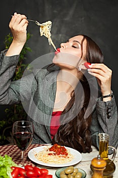 Attractive woman eating testy italian pasta in restaurant