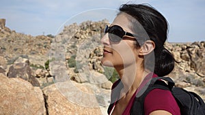 An attractive woman enjoys hiking Joshua Tree National Park
