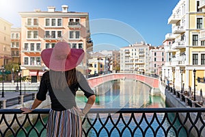Woman enjoys the view to the Venice like Qanat Quartier on the Pearl in Doha photo