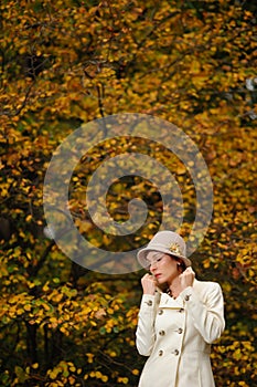 Attractive woman in evening autumn park