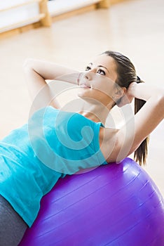 Attractive woman exercising with fitness ball