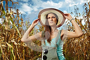 Attractive woman farmer in the cornfield