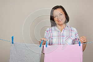 Attractive Woman Hanging Wet Clean Cloth To Dry On Clothes Line