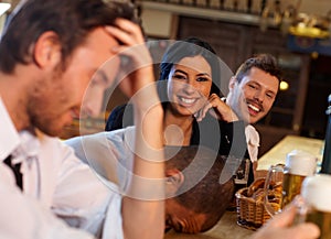 Attractive woman having fun with friends in pub