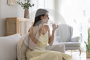 Attractive woman having remote conversation using speakerphone
