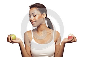 Attractive woman with healthy and unhealthy food, diet and healthy eating concept