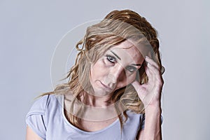 Attractive woman on her thirties sad and depressed looking at the camera in sorrow