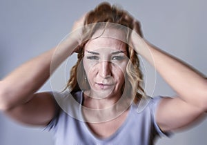 Attractive woman on her thirties sad and depressed looking at the camera in sorrow and grief