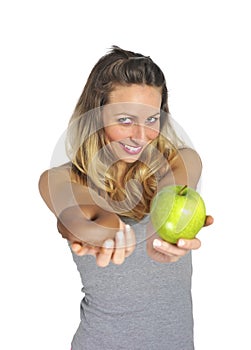 Attractive woman holding apple and chocolate donut in healthy fruit versus sweet junk food temptation