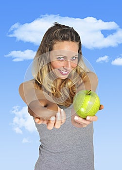 Attractive woman holding apple and chocolate donut in healthy fruit versus sweet junk food temptation