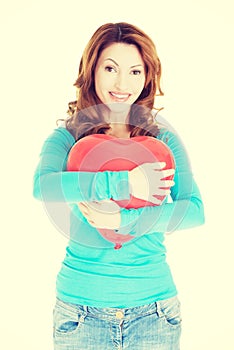 Attractive woman holding a baloon heart.