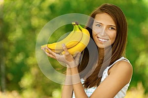 Attractive woman holding bananas